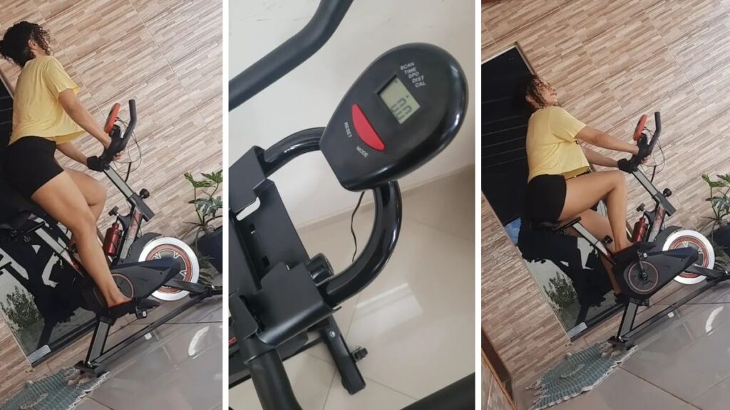 Visão aproximada do painel LCD, guidão e botão de resistência da Sevenfit EPS-988.