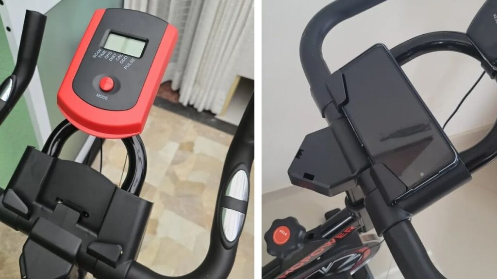 Vista aproximada do suporte de dispositivos móveis na Bicicleta Sevenfit EPS-988, com um smartphone fixado.